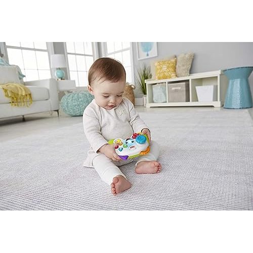 Manette éducative Fisher-Price pour bébés, avec boutons colorés et sons pour apprentissage ludique.