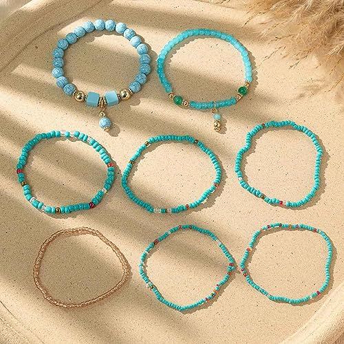 Bracelet fantaisie multicouche pour femme, perles et pompons, accessoire tendance, adaptable à tous les styles et occasions, polyvalent et élégant.