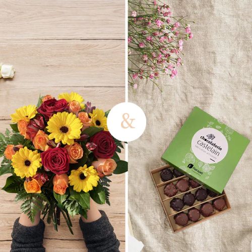 Bouquet de fleurs orange gourmand et coloré avec une boîte de chocolats, idéal pour exprimer gratitude et joie.